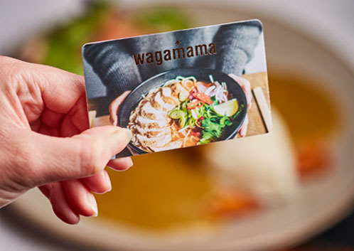 wagamama gift card being held above food